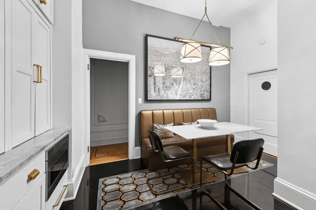 a kitchen with white cabinets and white appliances