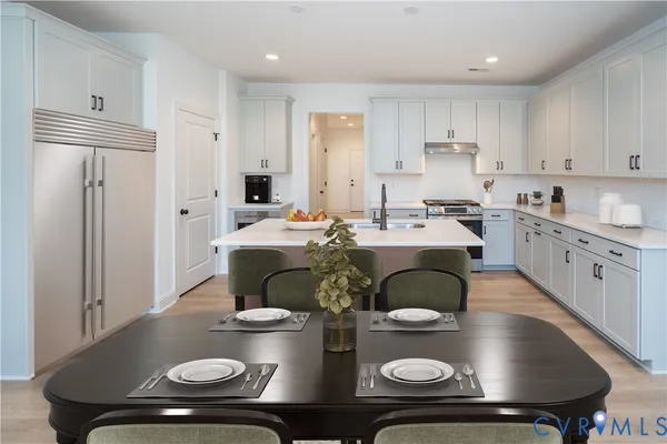 a kitchen with stainless steel appliances granite countertop a sink dishwasher stove refrigerator and cabinets