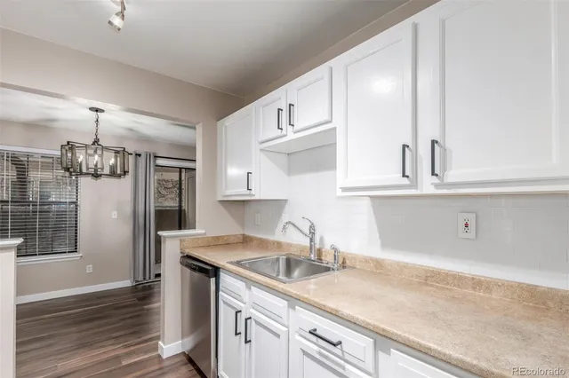a kitchen with stainless steel appliances granite countertop a sink and a refrigerator