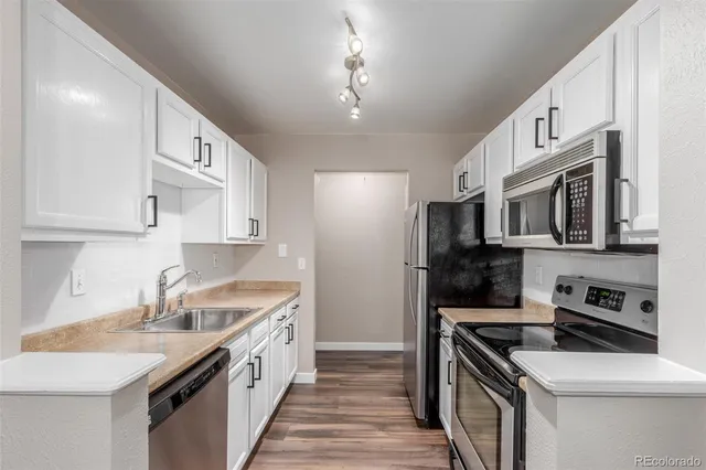 a kitchen with stainless steel appliances granite countertop a sink stove oven and refrigerator