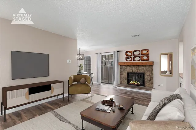 a living room with furniture and a fireplace