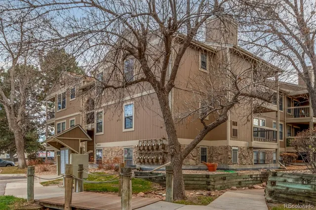 a front view of a building with large trees