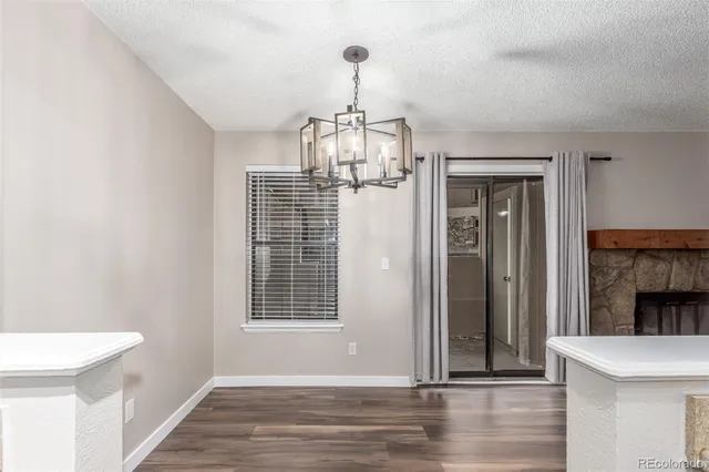 a view of empty room with wooden floor and fireplace
