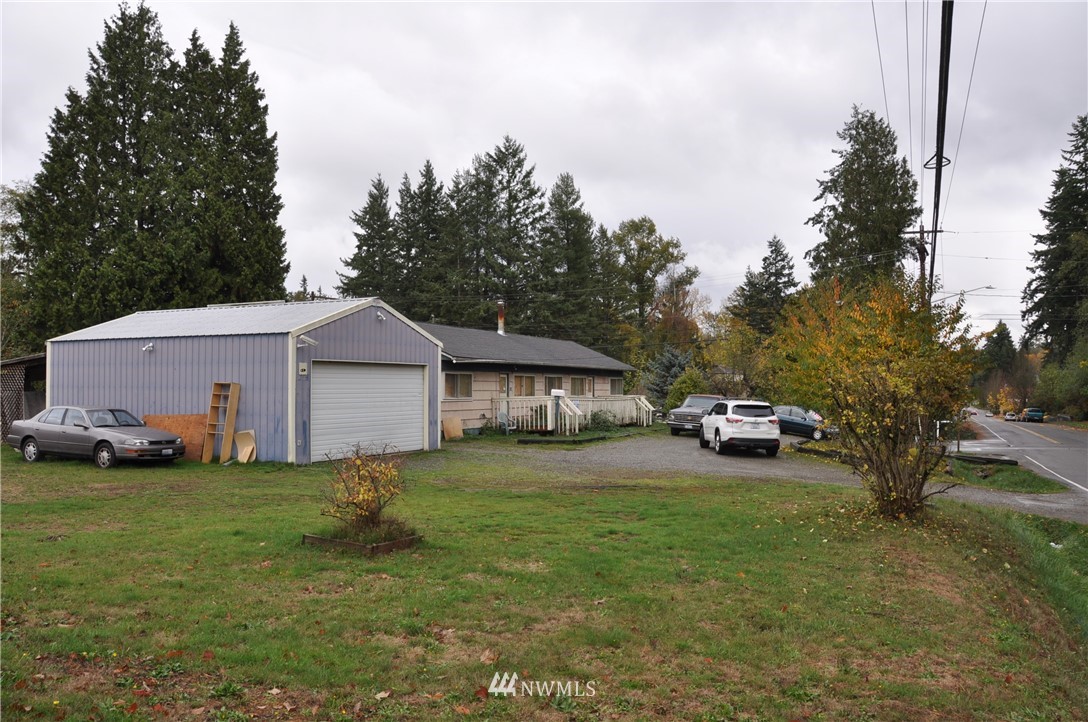 2017 Gibson Road Everett, WA 98204 - Photo 1 of 8 a view of a backyard with a house and large trees
