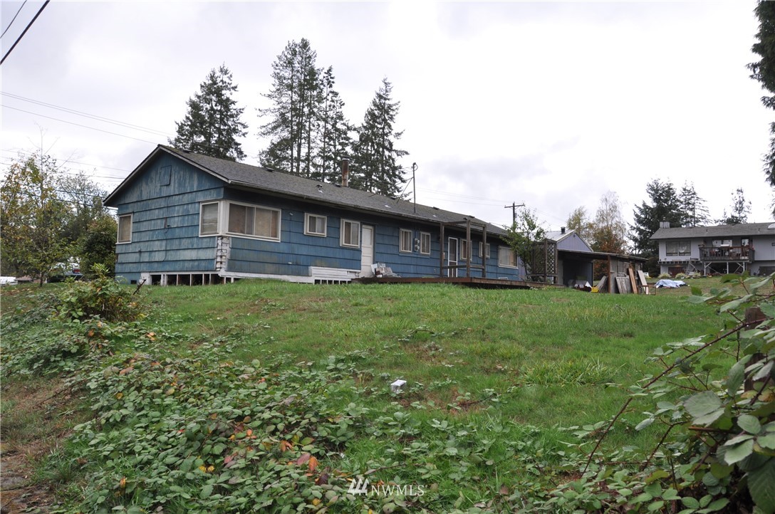 2017 Gibson Road Everett, WA 98204 - Photo 3 of 8 a view of a house with a big yard and large trees