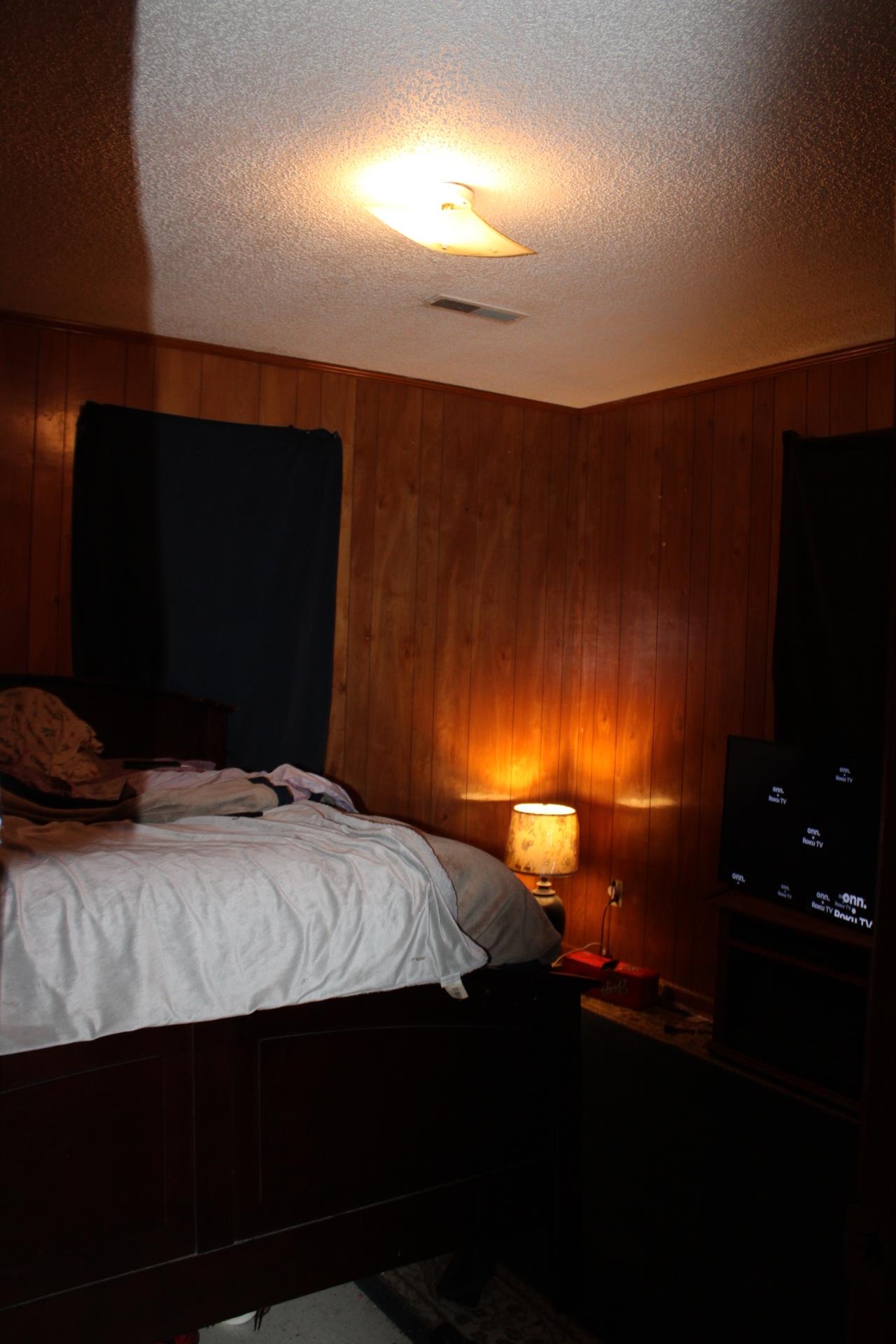 187 Land Avenue Ripley, TN 38063 - Photo 14 of 22 a bedroom with a bed and a lamp