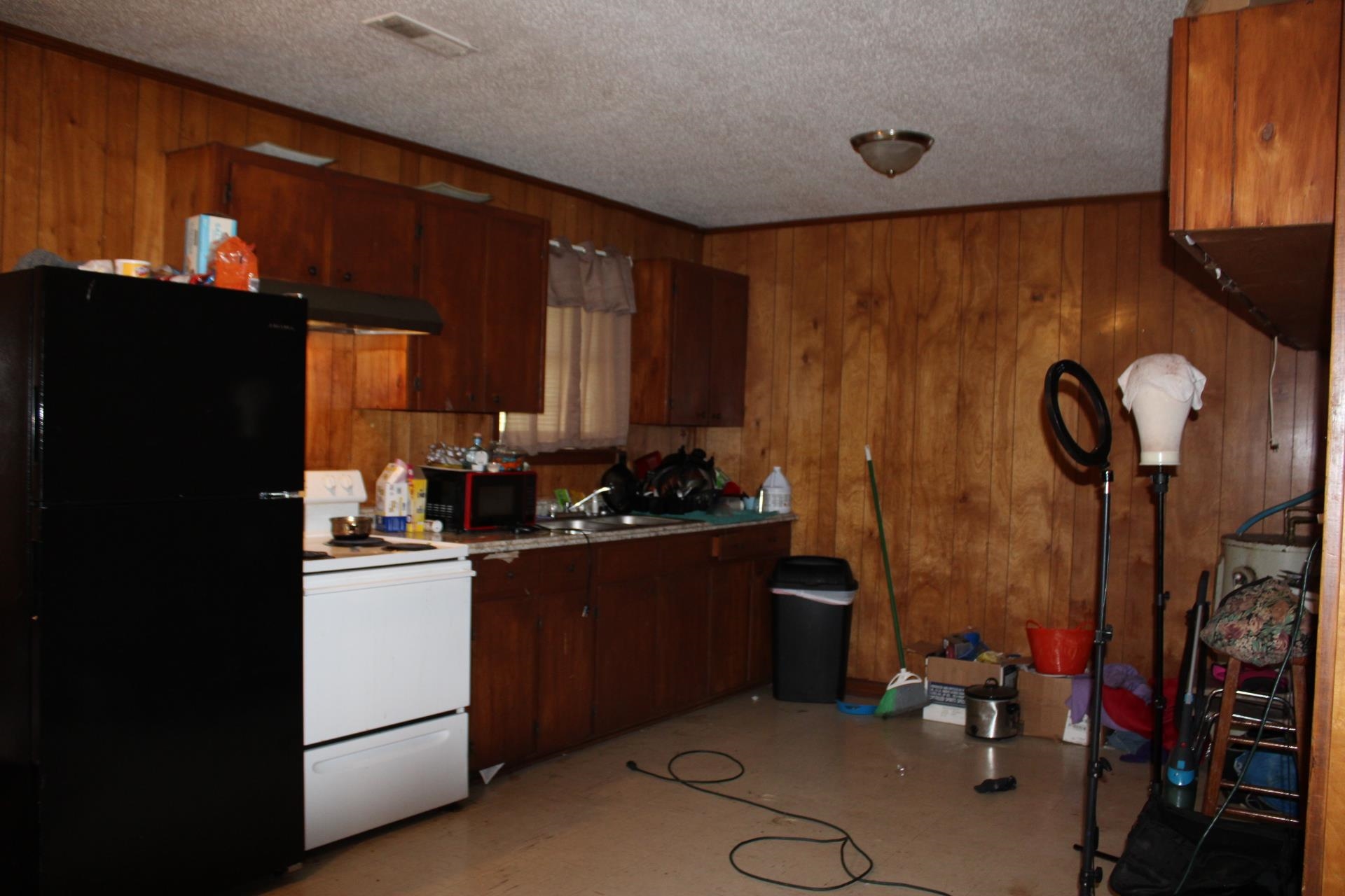 187 Land Avenue Ripley, TN 38063 - Photo 10 of 22 a kitchen with a sink refrigerator and cabinets