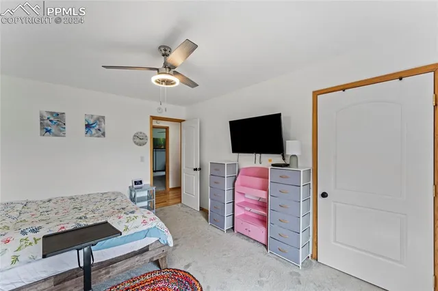 a view of a hallway with bathroom and wooden floor