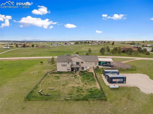 a house view with swimming pool next to a yard