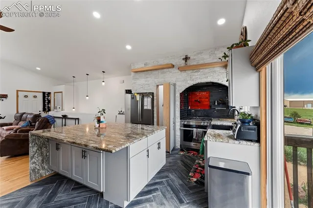 a kitchen with stainless steel appliances granite countertop a stove and a sink