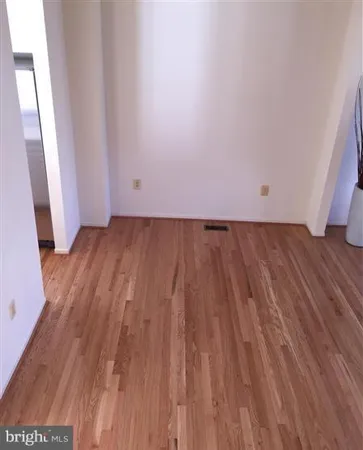 an empty room with wooden floor