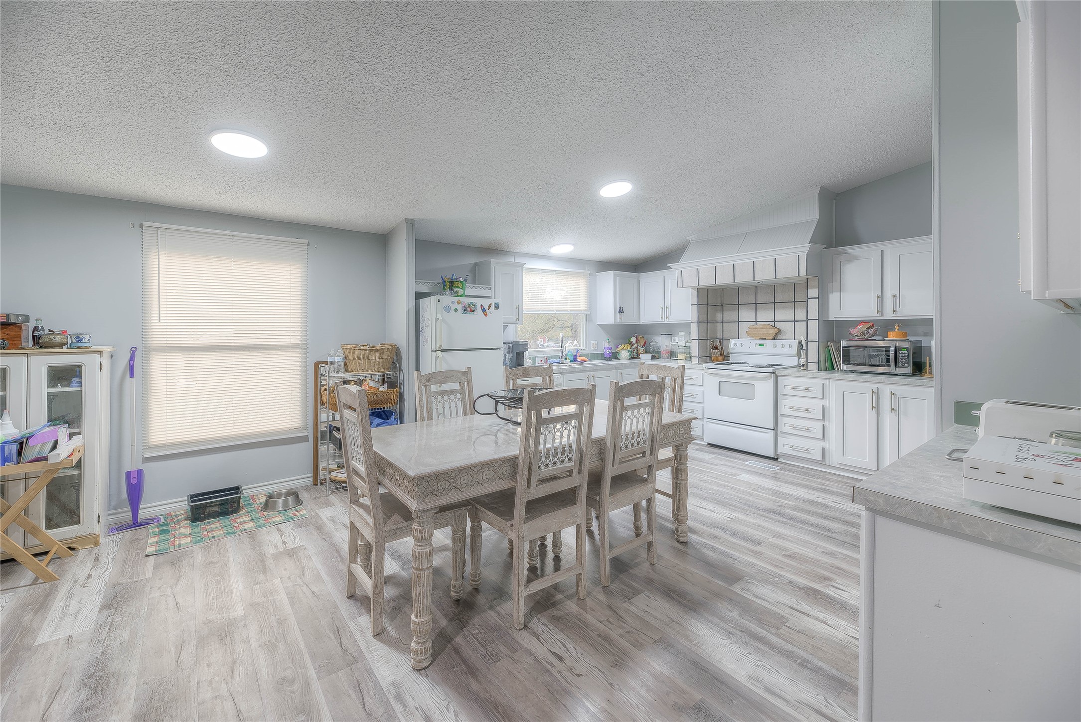 17709 Pine View Drive Conroe, TX 77302 - Photo 13 of 26 a kitchen with stainless steel appliances kitchen island granite countertop a table chairs and a refrigerator
