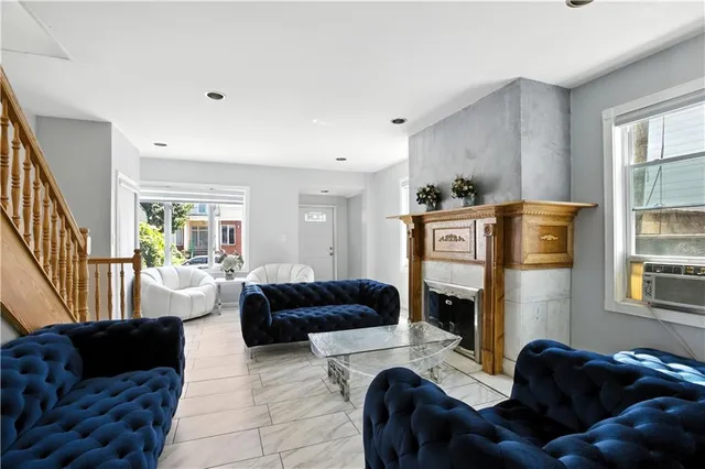 a living room with furniture and a fireplace