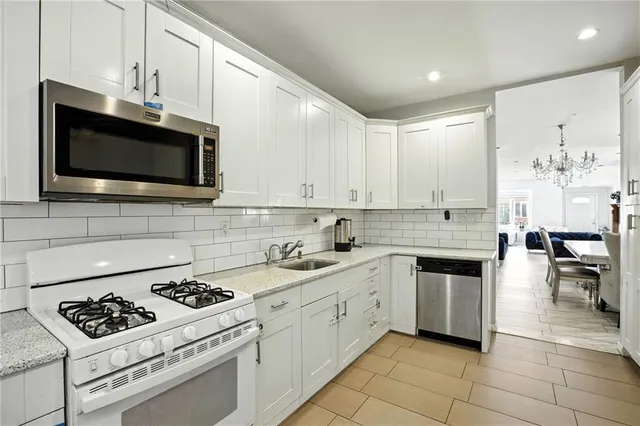 a kitchen with cabinets and steel appliances