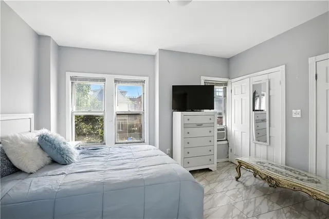 a bedroom with a bed and a flat screen tv