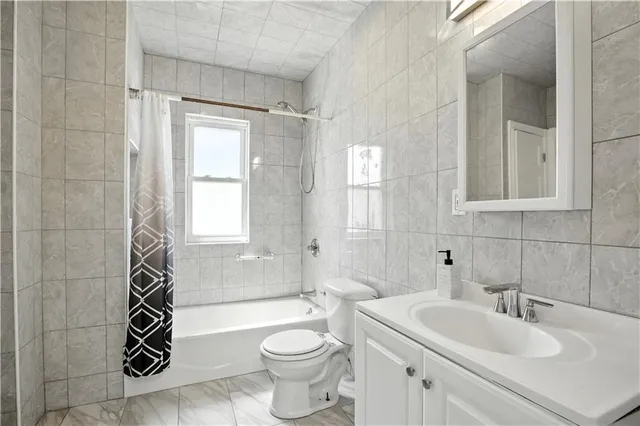 a bathroom with a sink toilet a mirror and shower
