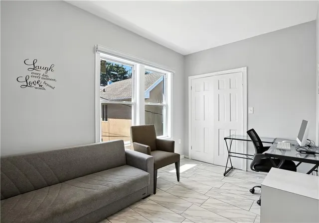 a living room with furniture and large windows