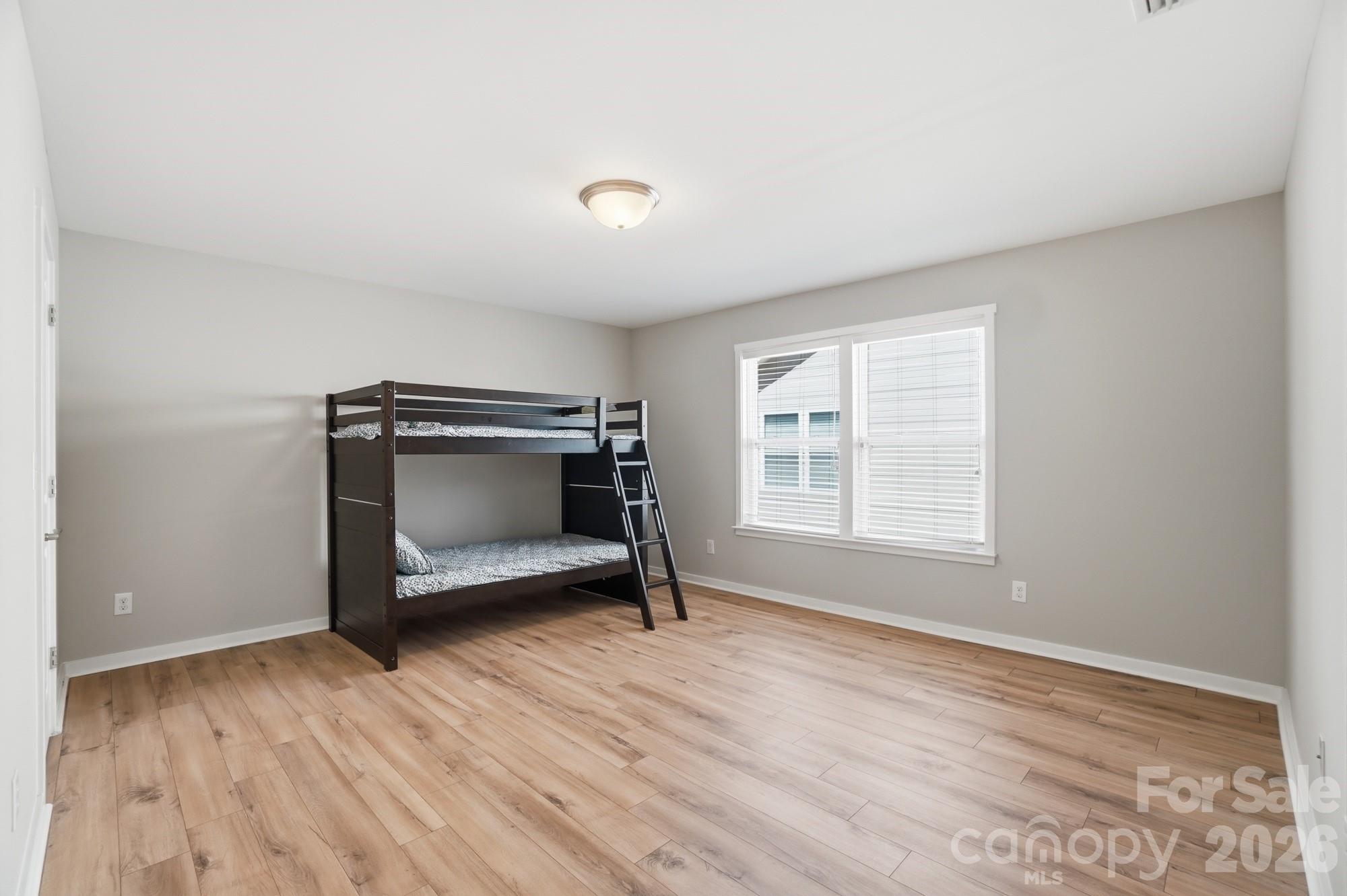 2153 Bluebell Way Tega Cay, SC 29708 - Photo 40 of 48 a view of an empty room with wooden floor and a window