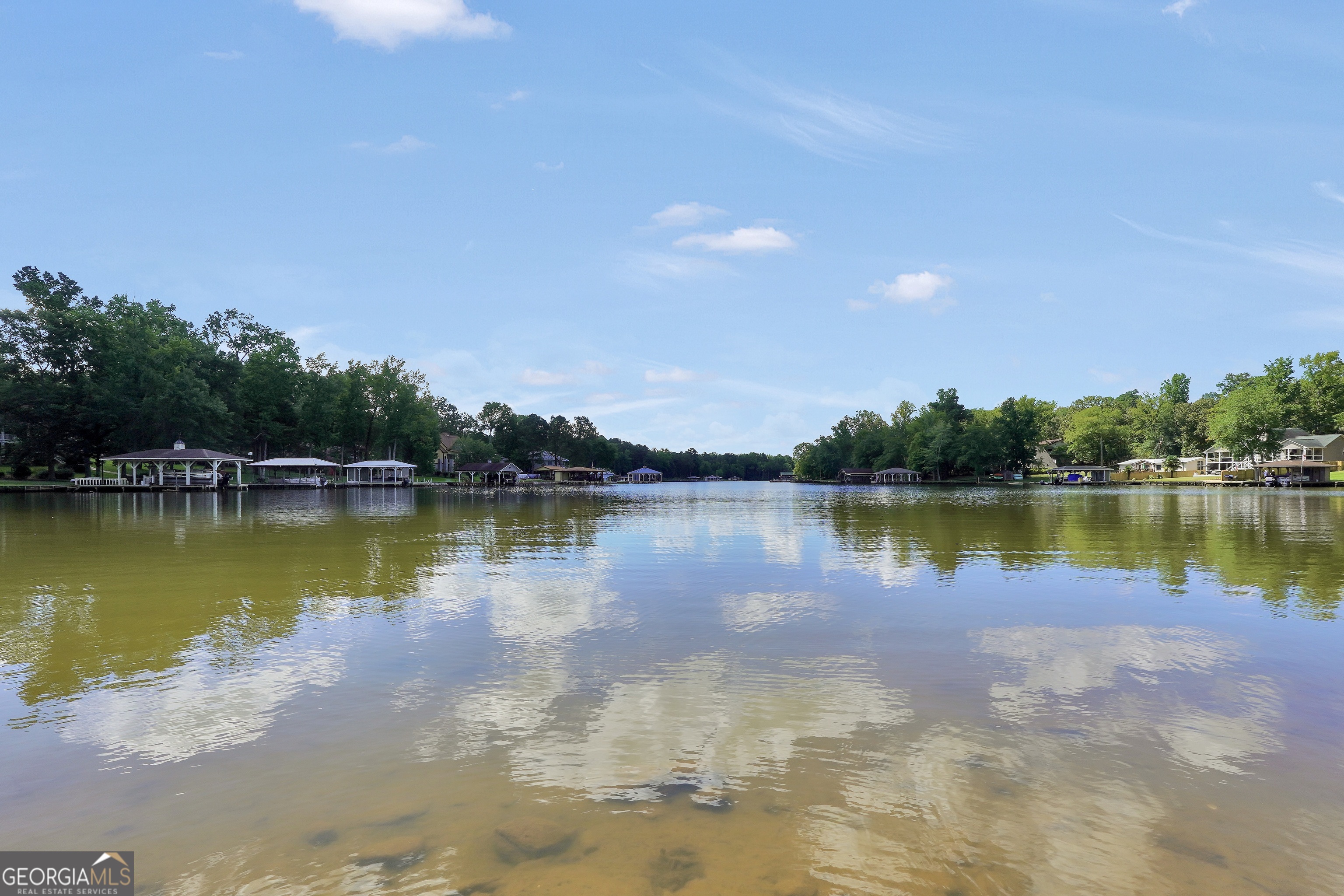 0 Scuffleboro Road Southeast Eatonton, GA 31024 - Photo 17 of 77 a view of a lake with houses in the background