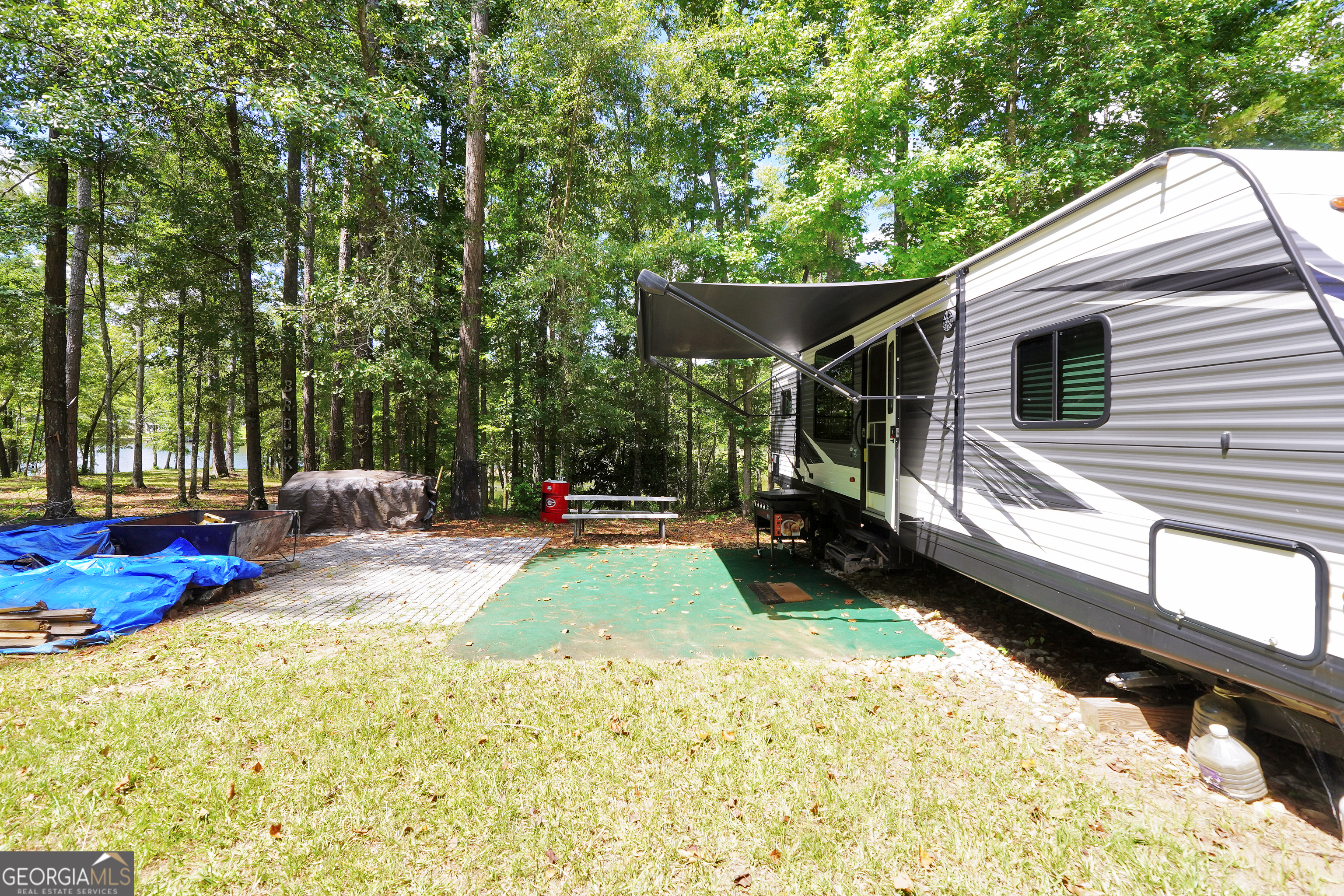 0 Scuffleboro Road Southeast Eatonton, GA 31024 - Photo 27 of 77 a view of a chair and tables in the back yard of the house