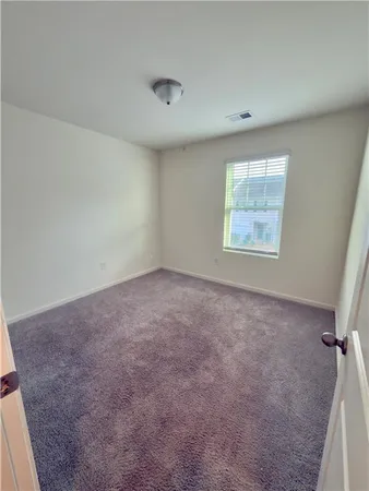 a bathroom with a sink a toilet a mirror and shower