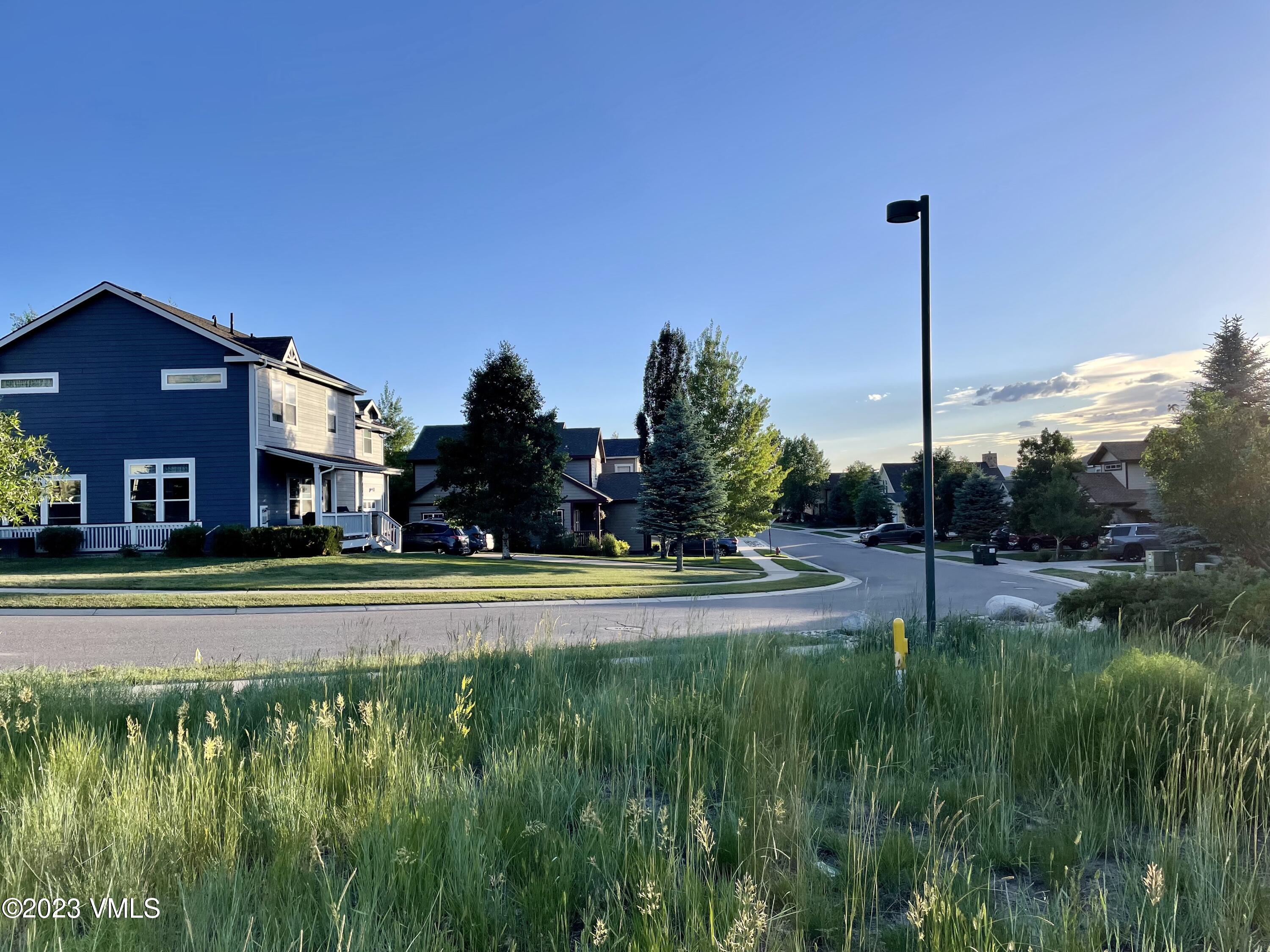 350 Bluffs Drive Eagle, CO 81631 - Photo 3 of 5 a view of a house with a big yard and a large trees with a small yard