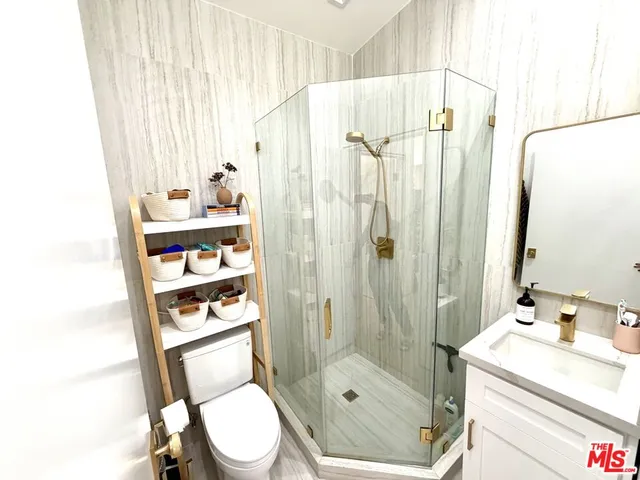 a bathroom with a shower a toilet and a sink