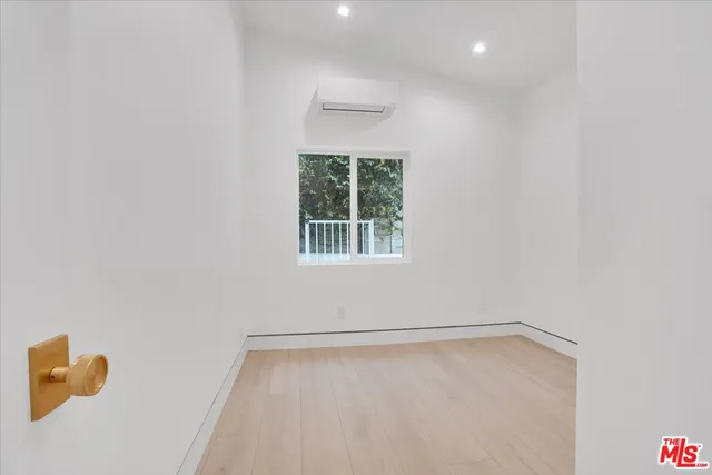 a hallway with beautiful frames and flower plants