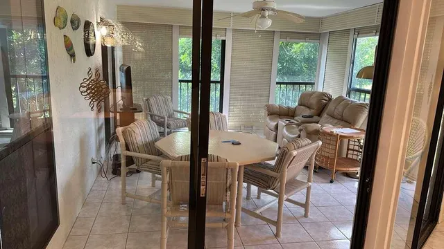 a view of a dining room with furniture and a window