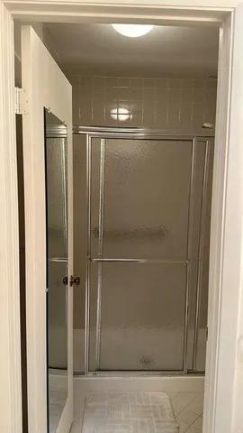 a bathroom with a glass shower door