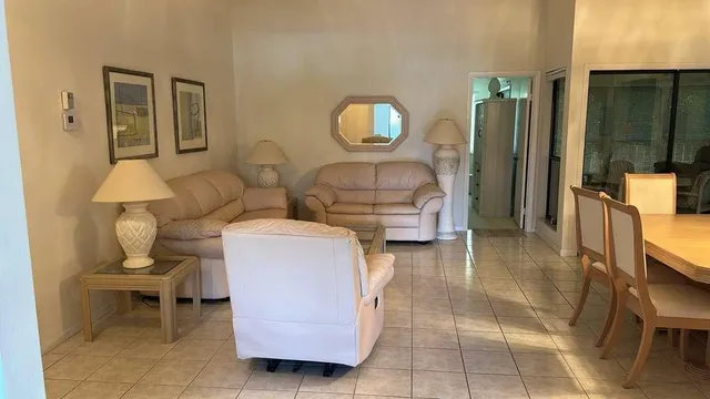 a living room with furniture and a mirror