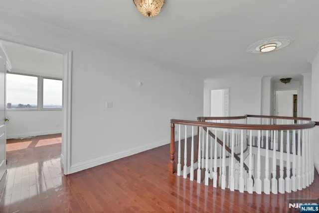 a view of hallway with wooden floor