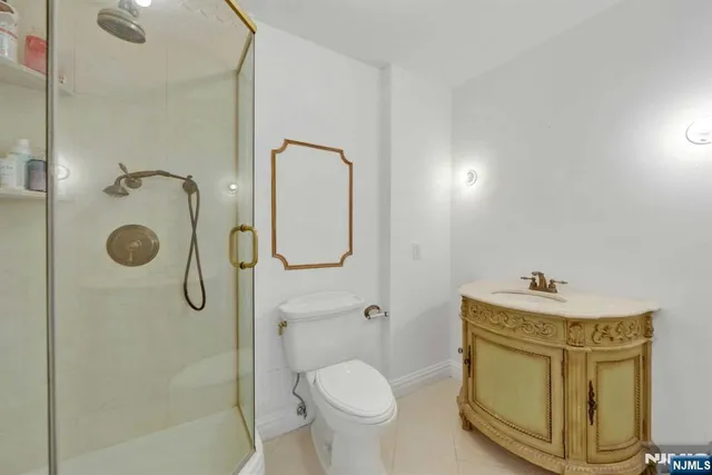 a bathroom with a granite countertop toilet sink and shower