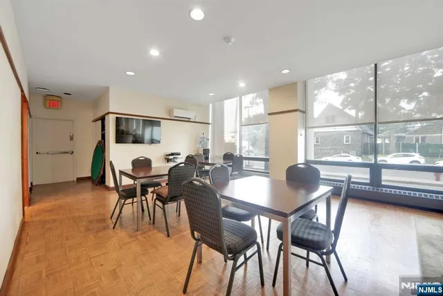 a dining room with furniture and wooden floor