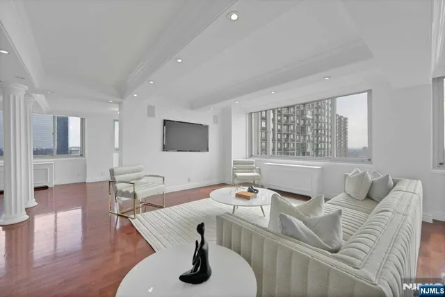 a living room with furniture and wooden floor