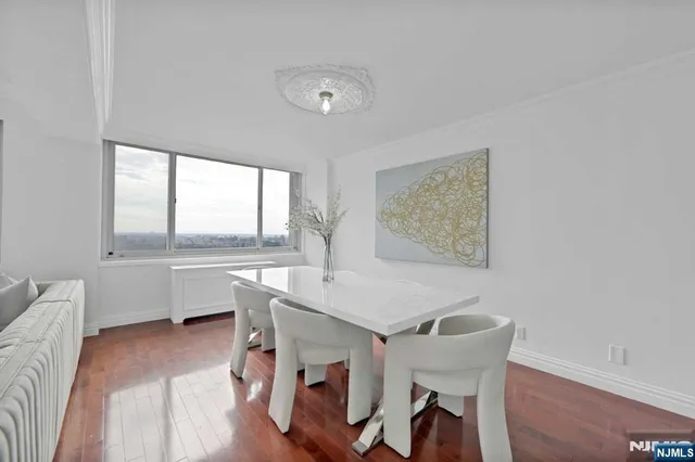 a view of a dining room with furniture and a window