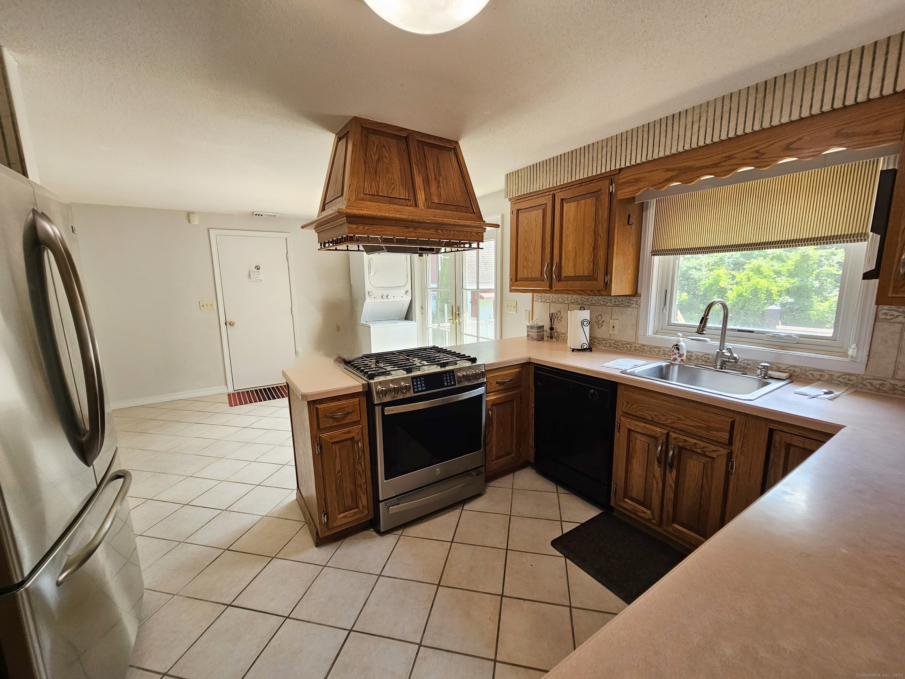 105 Minortown Road Woodbury, CT 06798 - Photo 13 of 35 a kitchen with stainless steel appliances granite countertop a sink a stove a refrigerator cabinets and a window