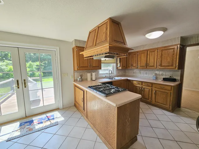 a kitchen with a stove a sink and a refrigerator