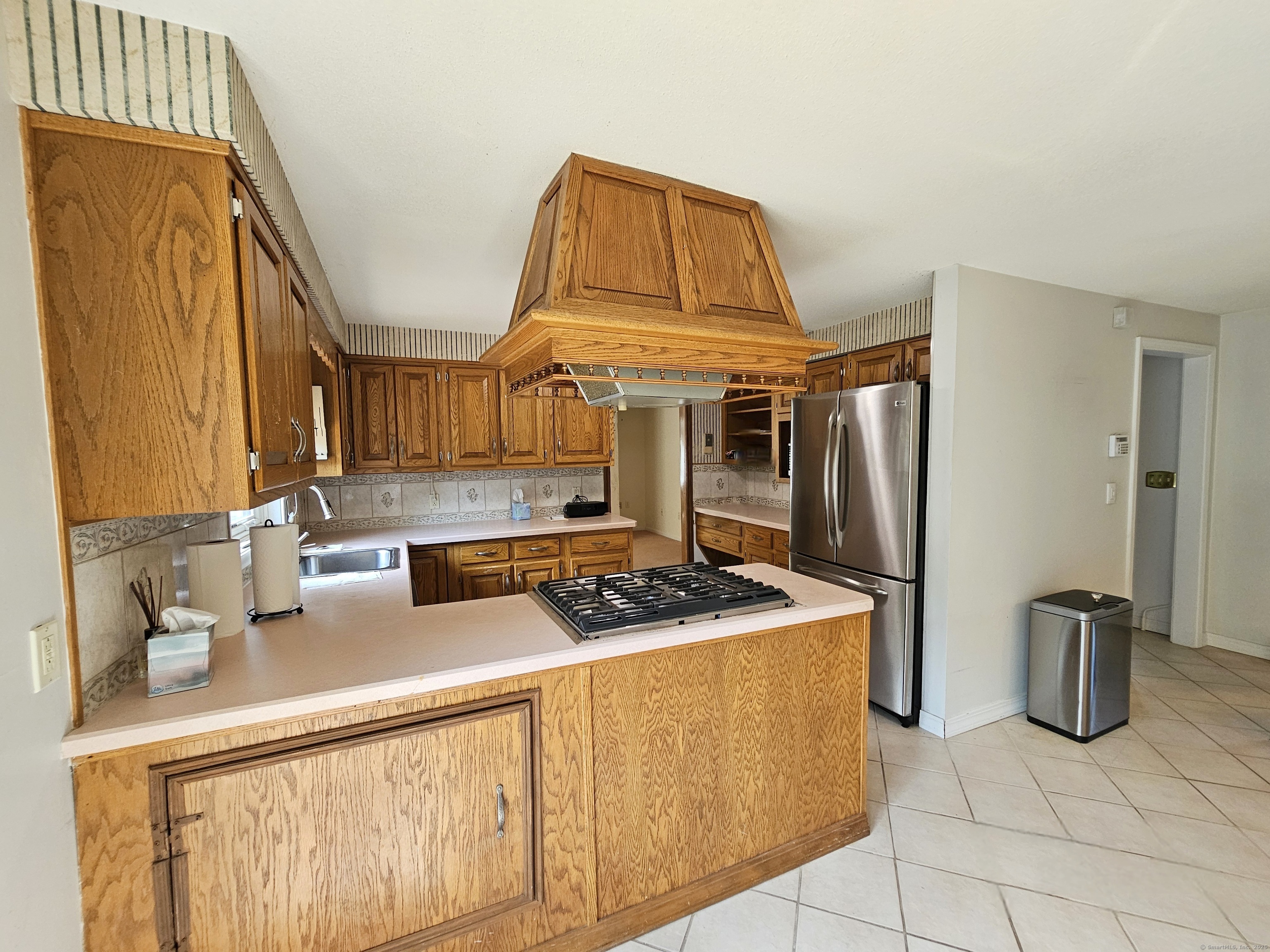 105 Minortown Road Woodbury, CT 06798 - Photo 16 of 35 a kitchen with stainless steel appliances granite countertop a sink a stove and a refrigerator