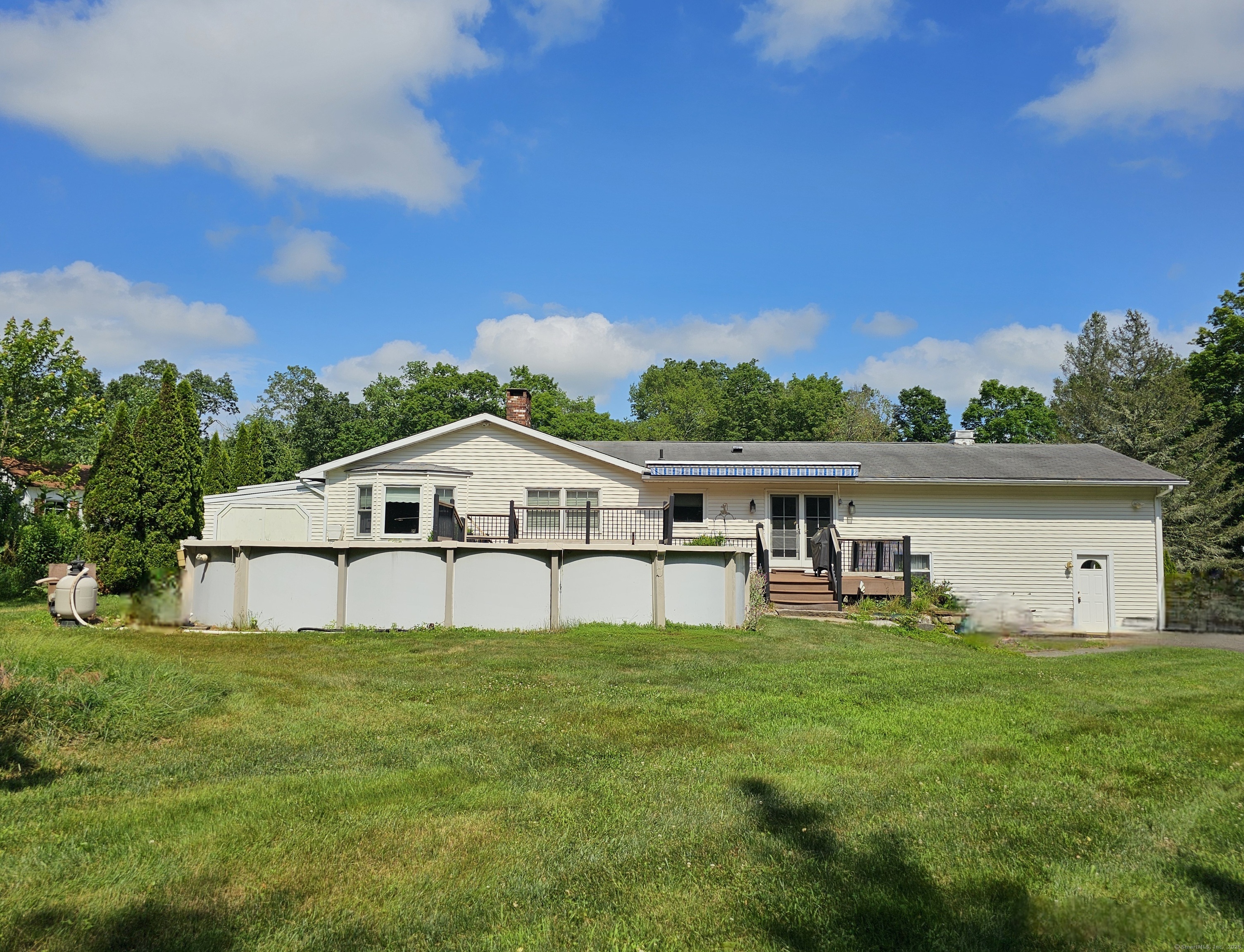 105 Minortown Road Woodbury, CT 06798 - Photo 4 of 35 a house that is sitting in the grass with large trees and plants