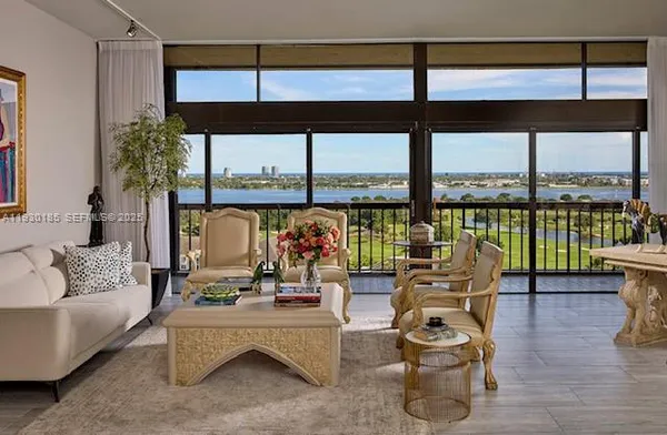 a living room with furniture and a floor to ceiling window