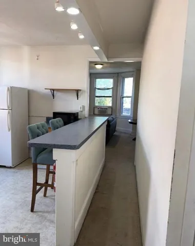 a kitchen with counter top space and windows