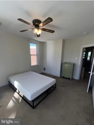 a bed sitting in a room next to a window