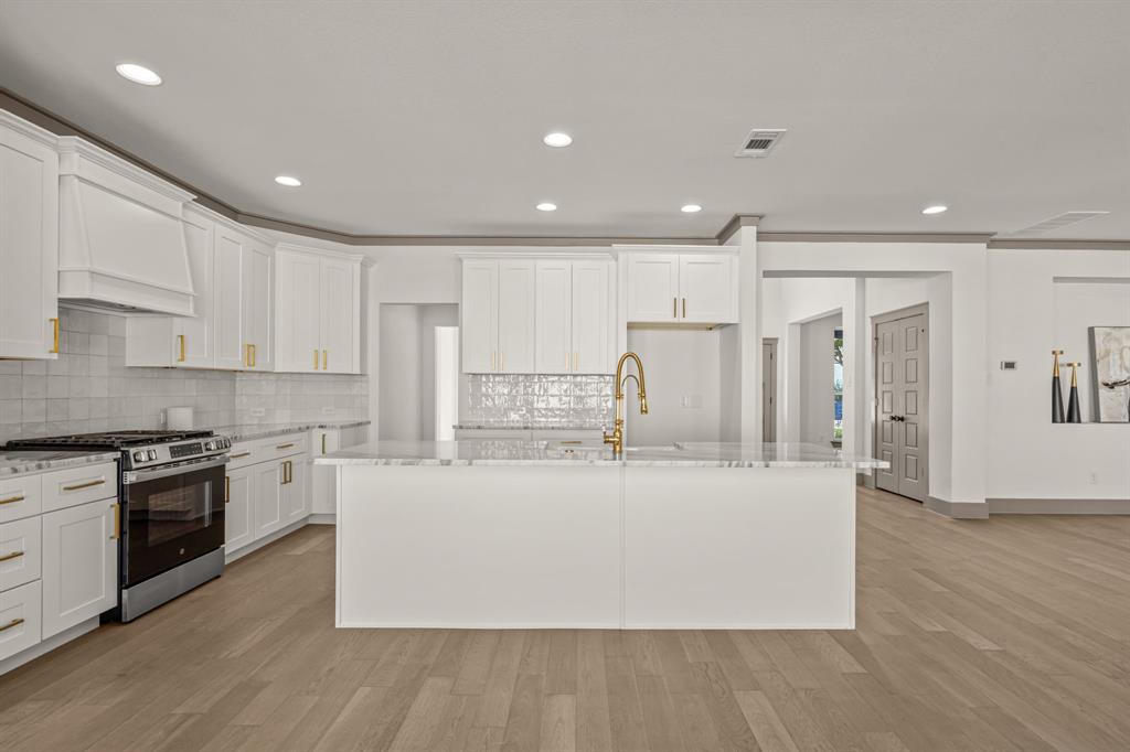 5720 Randolph Court Westworth Village, TX 76114 - Photo 17 of 40 a large kitchen with stainless steel appliances granite countertop a stove a sink and a refrigerator