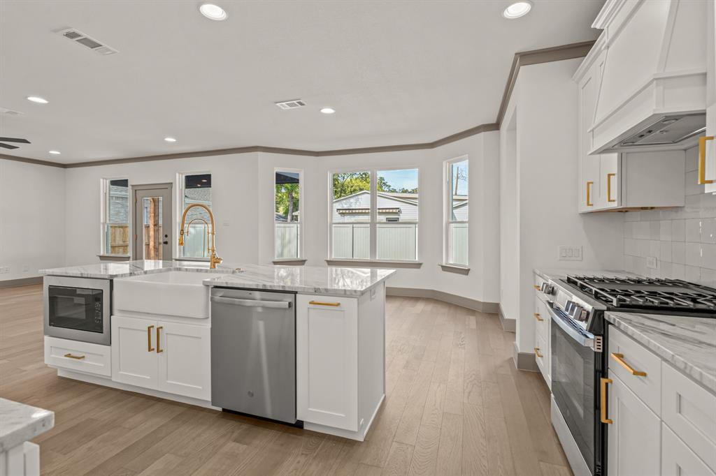 5720 Randolph Court Westworth Village, TX 76114 - Photo 19 of 40 a kitchen with stainless steel appliances granite countertop a stove and a sink