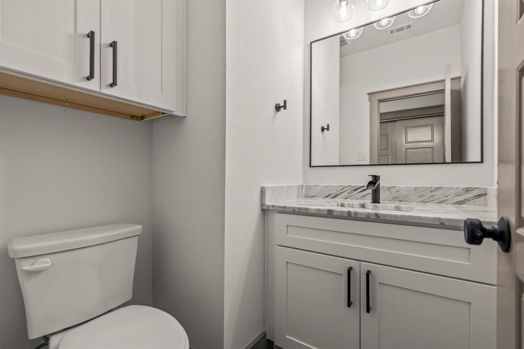 5720 Randolph Court Westworth Village, TX 76114 - Photo 23 of 40 a bathroom with a toilet sink and mirror