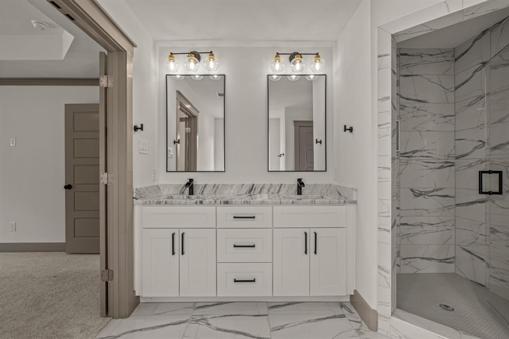 5720 Randolph Court Westworth Village, TX 76114 - Photo 29 of 40 a bathroom with a double vanity sink mirror and shower