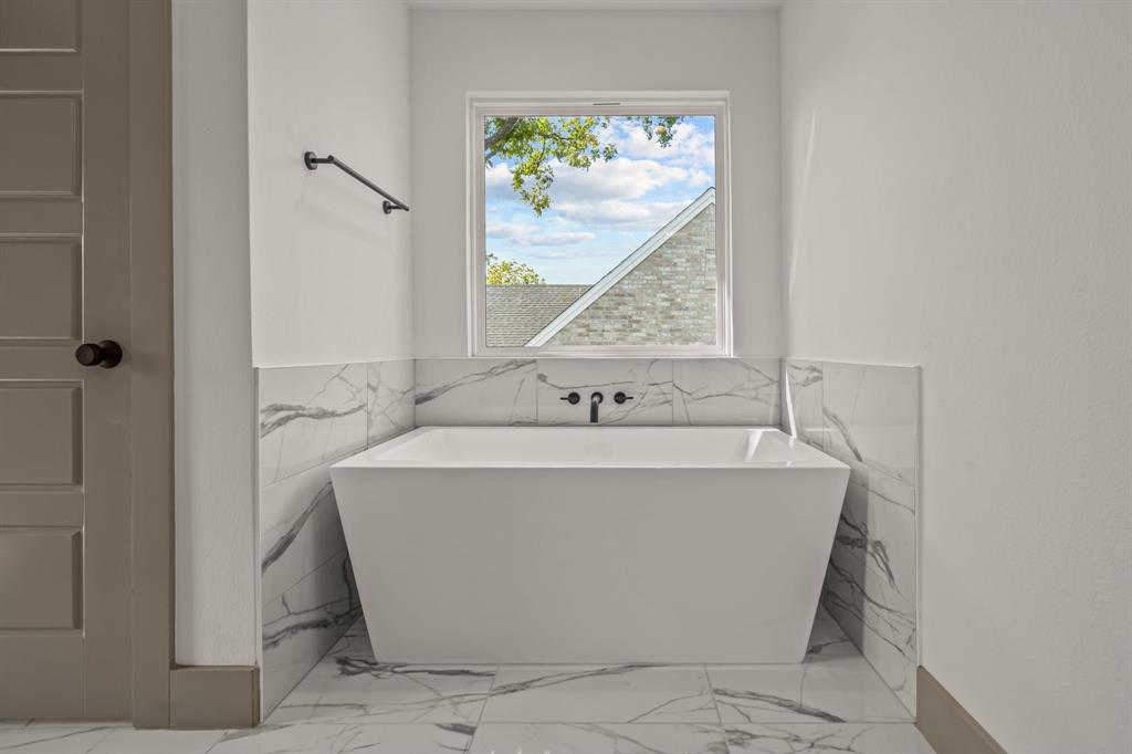 5720 Randolph Court Westworth Village, TX 76114 - Photo 30 of 40 a bathroom with a bathtub and window