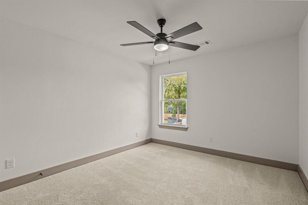 5720 Randolph Court Westworth Village, TX 76114 - Photo 31 of 40 an empty room with window and ceiling fan