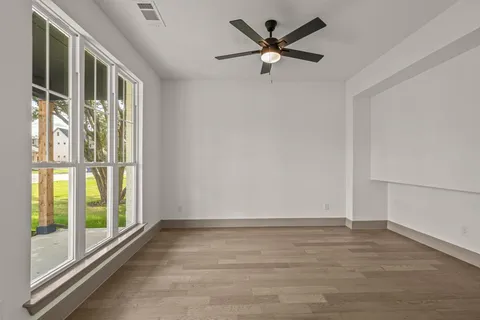 a view of a livingroom with a ceiling fan and window
